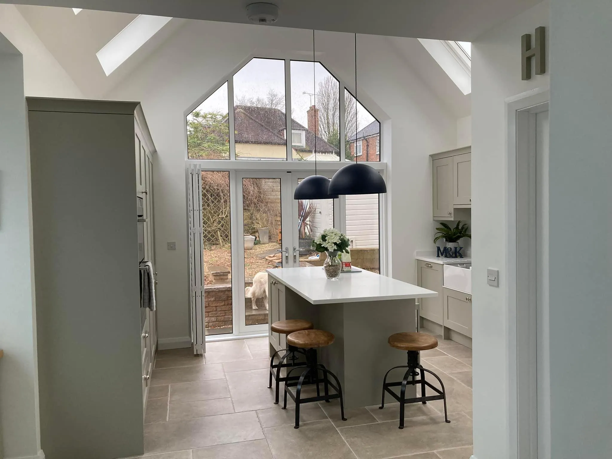 a kitchen with a large center island with stools
