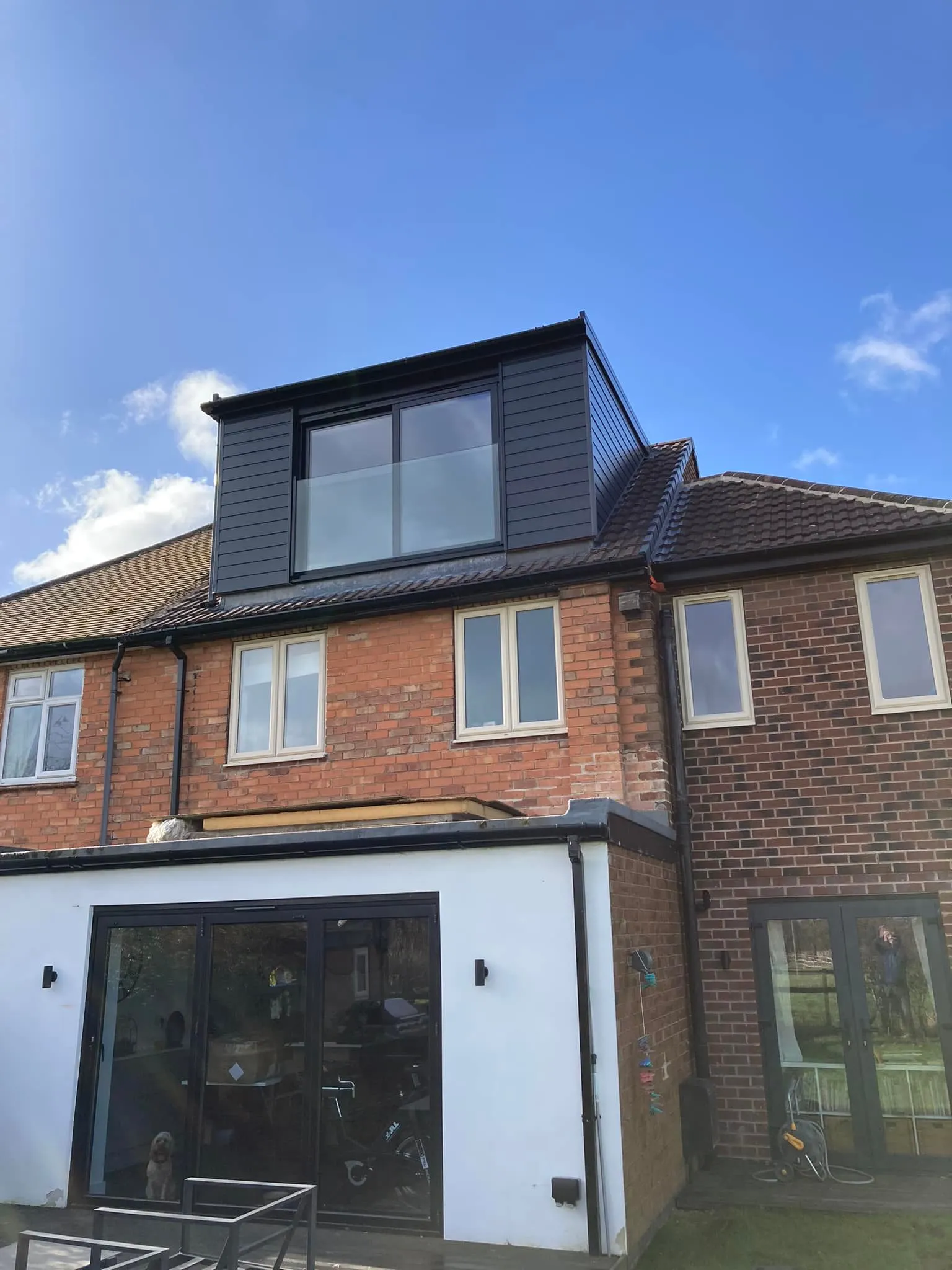 a house with a black roof and white walls