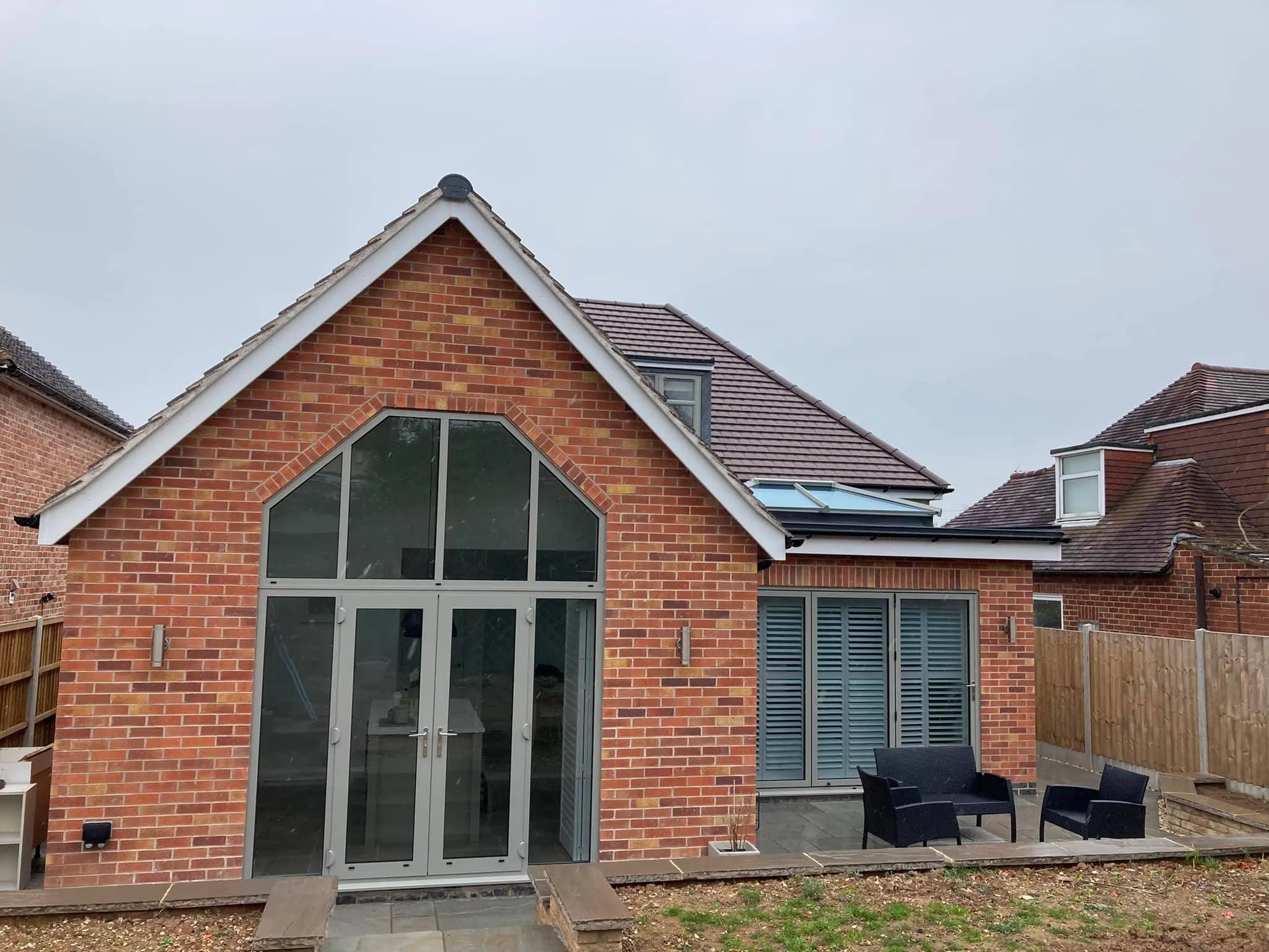 a brick house with a patio and patio furniture