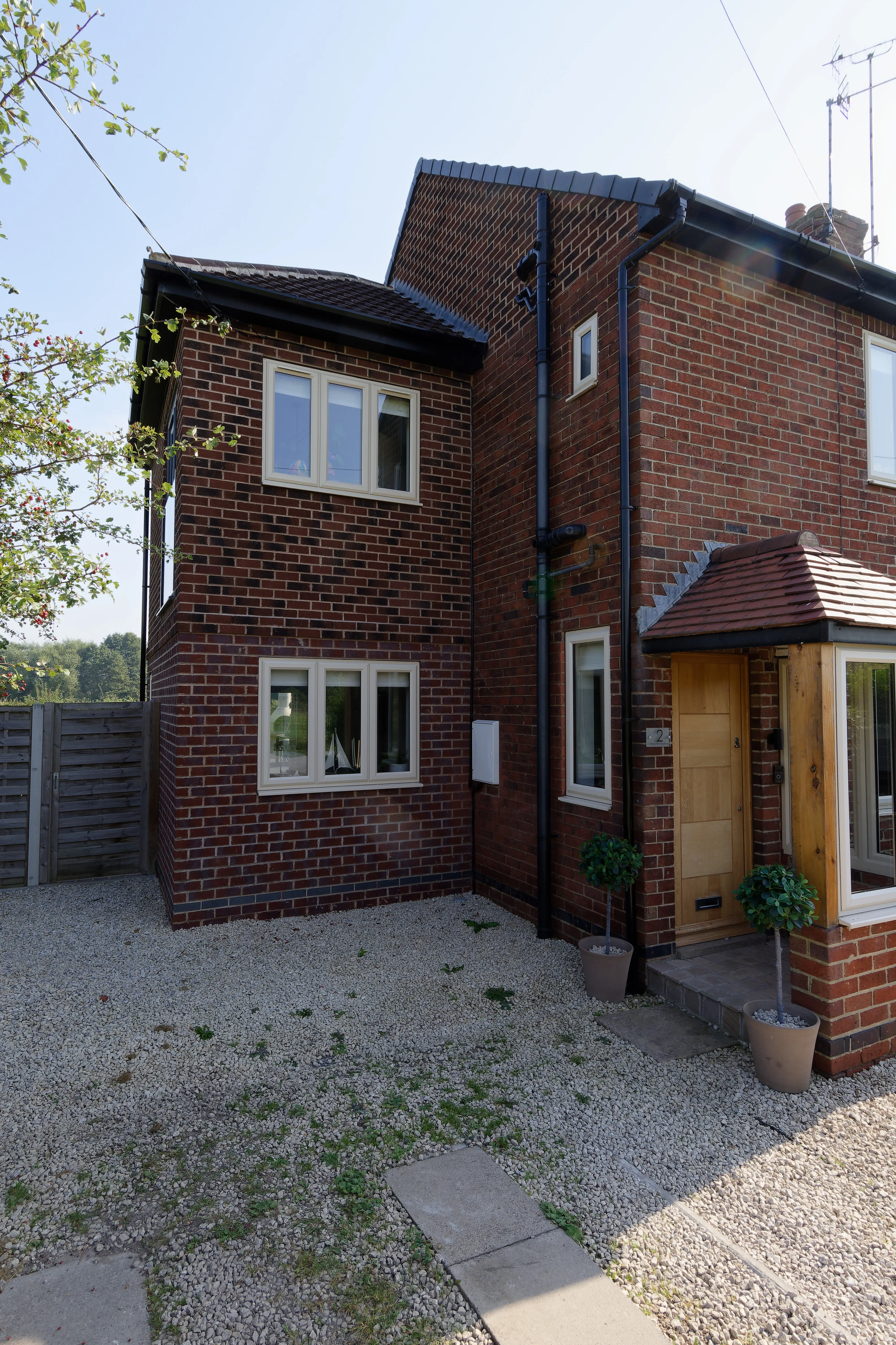 a brick house with a wooden door and windows