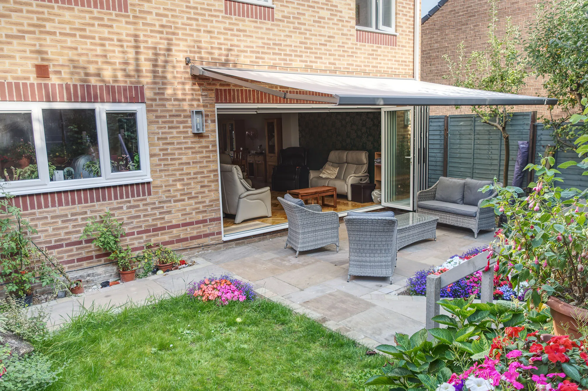 a patio area with chairs and a table
