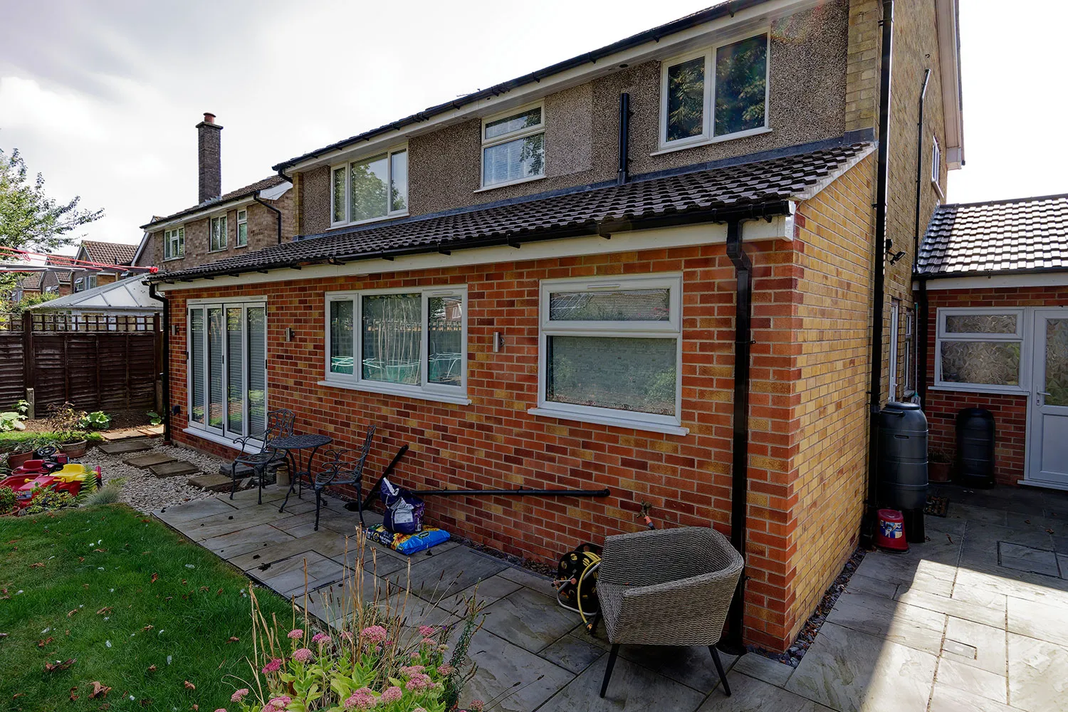 a brick house with a patio and a lawn chair