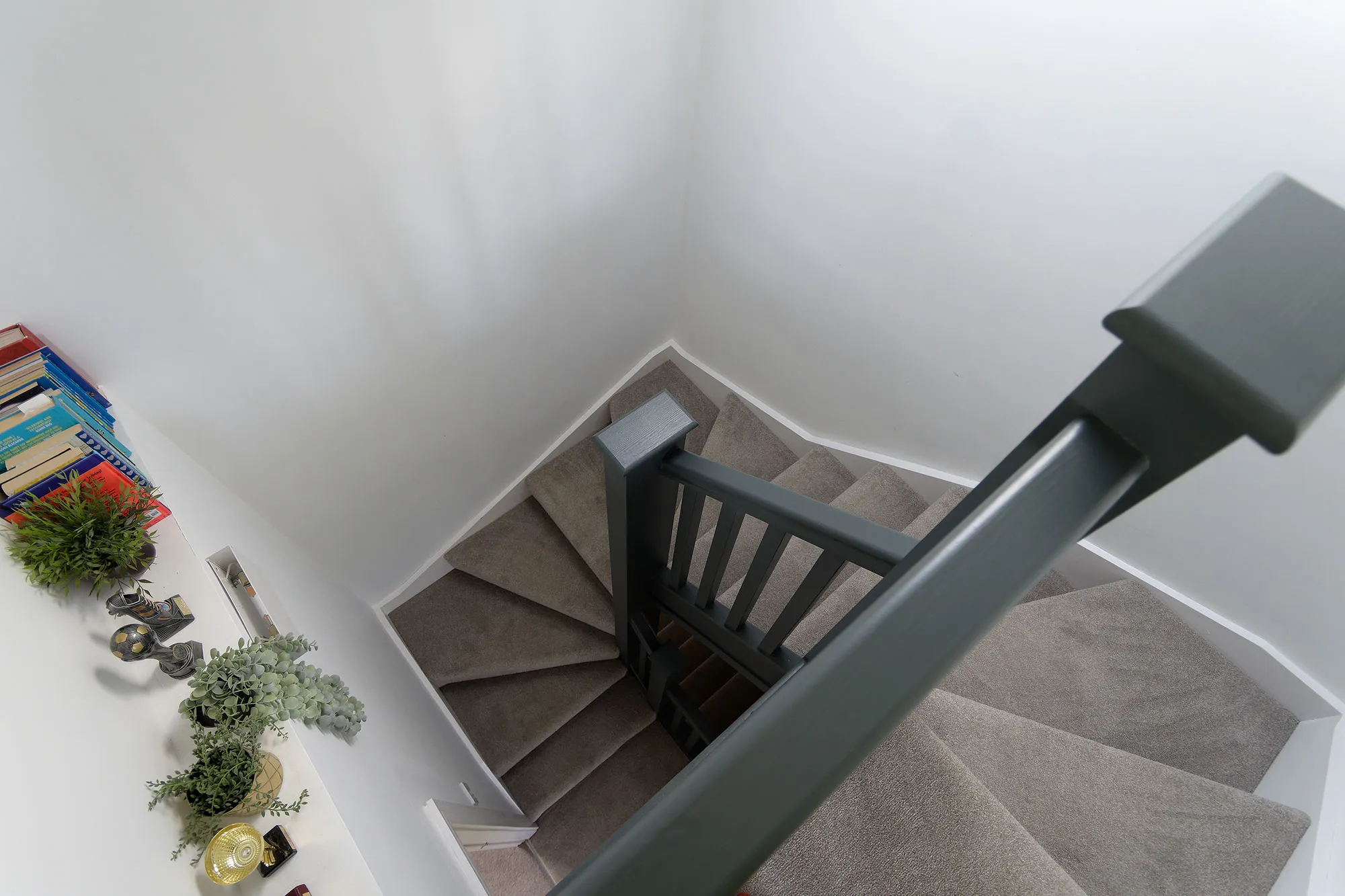 a view of a staircase from the top of a flight of stairs